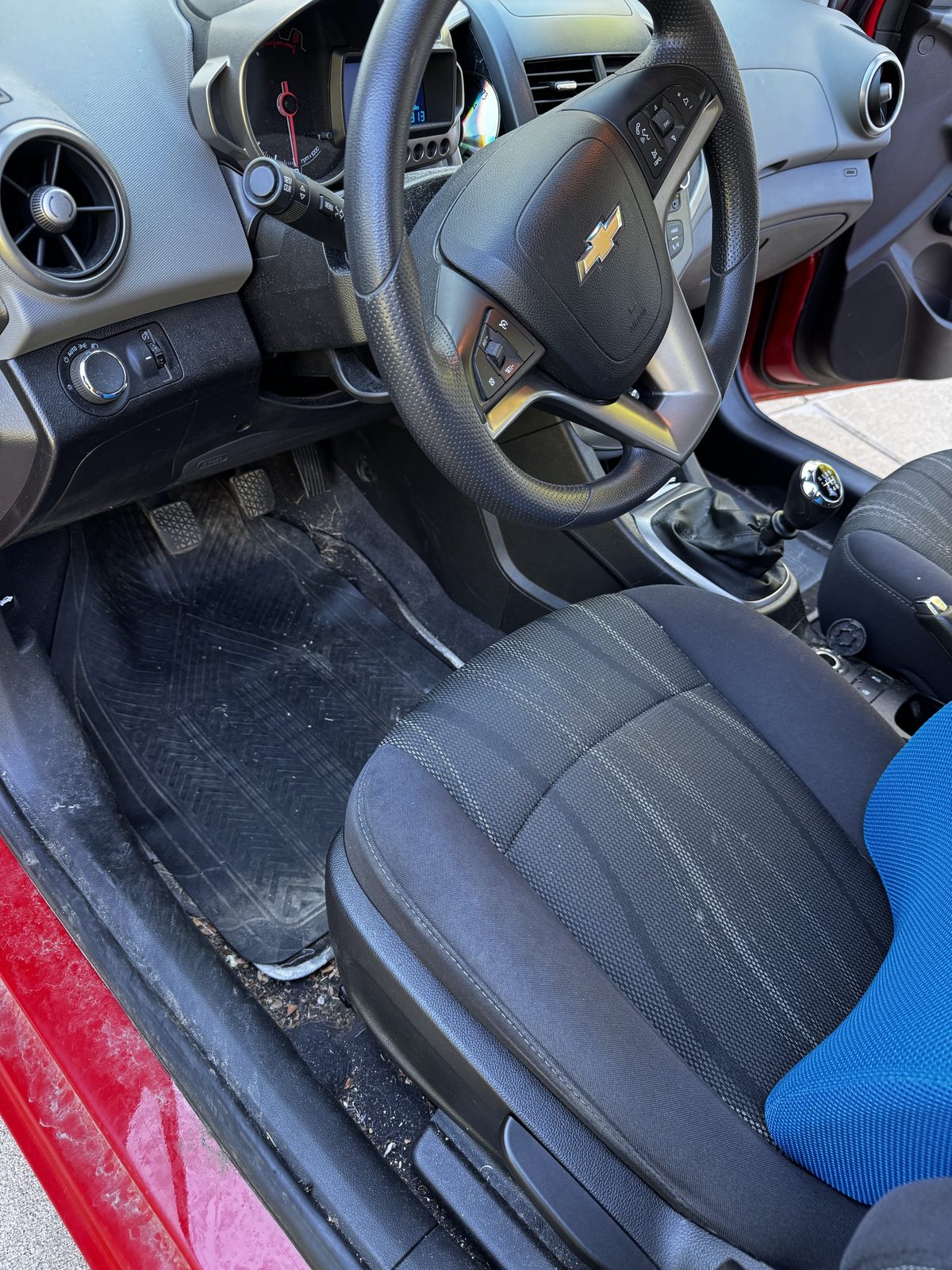 Car interior before detailing — dirty floor mats and grime