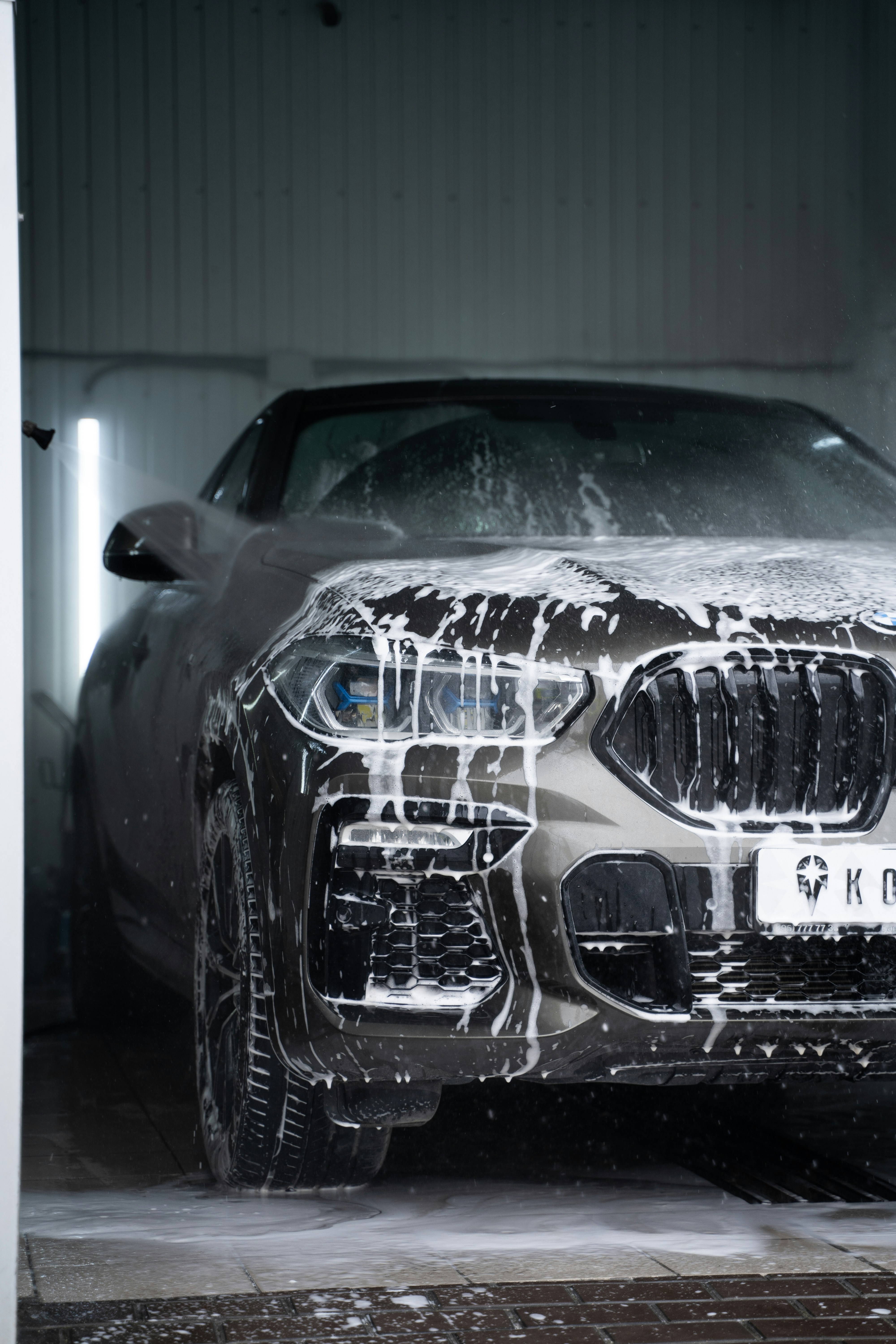 BMW being detailed with professional foam wash at Aero Detailing South Lyon MI