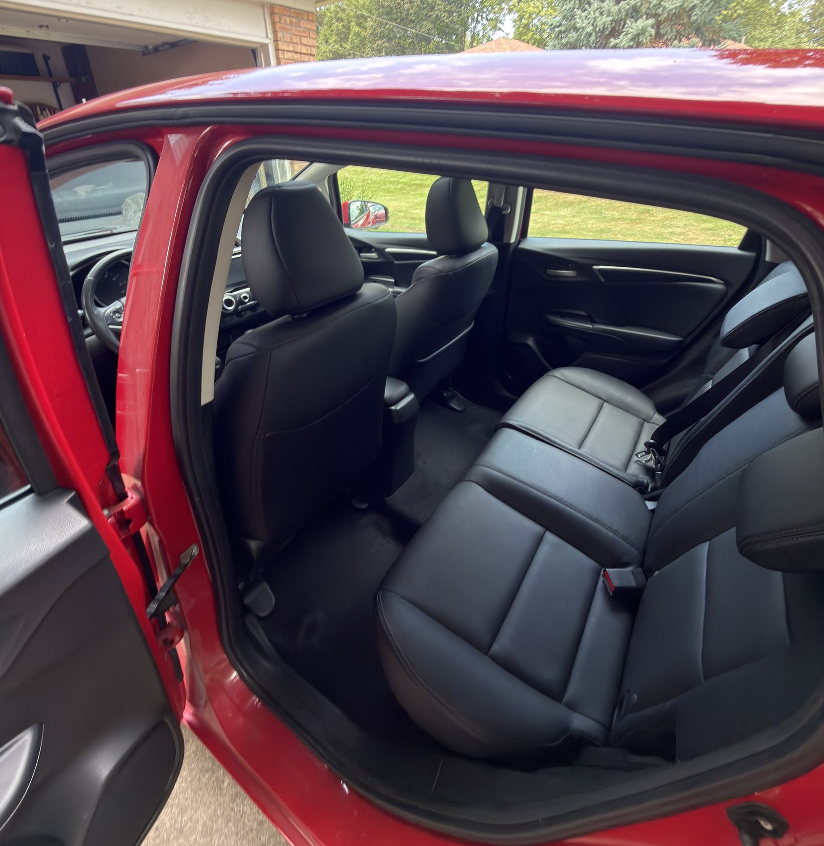 Honda Fit with doors open showing interior cleaned by Aero Detailing in South Lyon MI